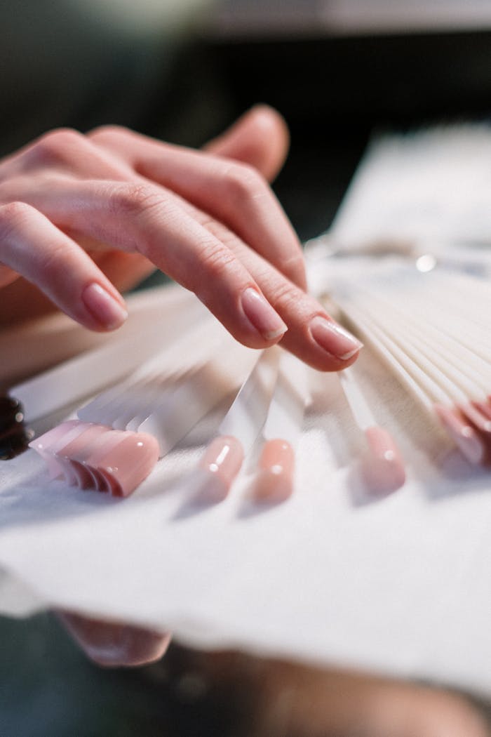 programs-02 Close-up of a woman's hand selecting nail polish colors in a beauty salon.
